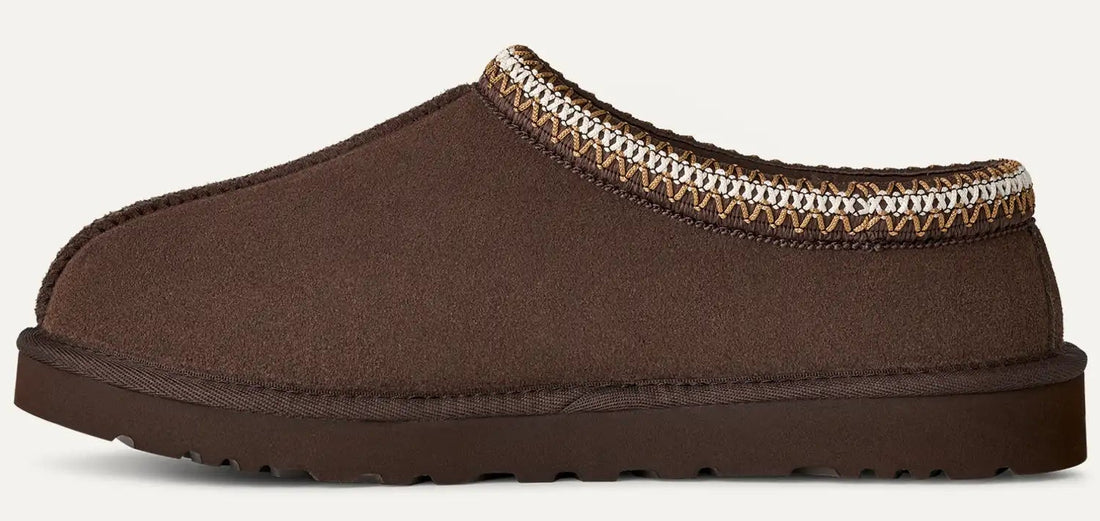 Brown slipper with patterned trim on a white background